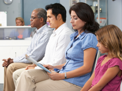 Image of patients waiting in a medical office lobby. 